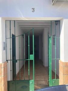 an empty room with green doors in a building at Mini casa en Alquiler in Albaida del Aljarafe