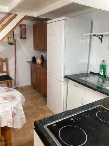 a kitchen with a white refrigerator and a counter top at Mini casa en Alquiler in Albaida del Aljarafe