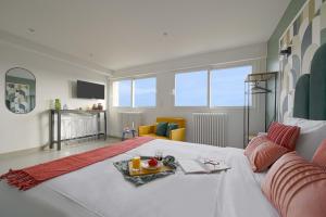 a bedroom with a bed with a tray of food on it at Modern bright Apartment in appart'hotel in Saint-Maur-des-Fossés