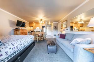 Habitación con cama, sofá y cocina. en Quaint Studio w/Lake View #146 at Donner Lake Village, en Truckee