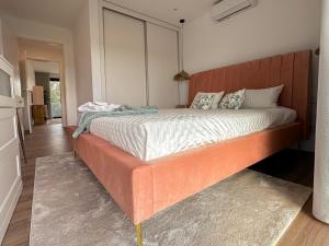 A bed or beds in a room at Flora Guest House