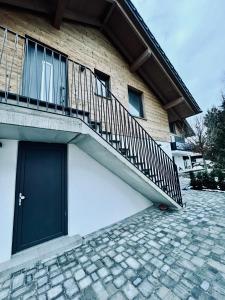a building with a staircase next to a door at Ferienwohnung zum Kalmbach in Kochel