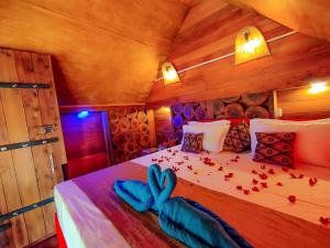 a bedroom with a bed with a blue bow on it at The Banda' Eco Villa in Sigiriya