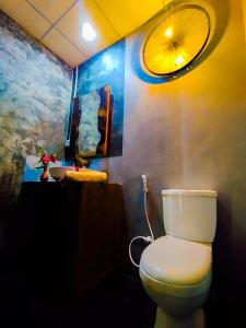 a bathroom with a toilet and a sink at The Banda' Eco Villa in Sigiriya