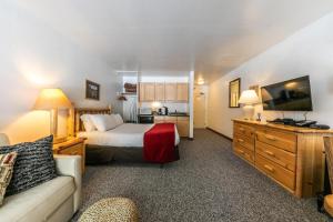 a hotel room with a bed and a couch at Modern Studio w/Balcony #211 at Donner Lake Village in Truckee
