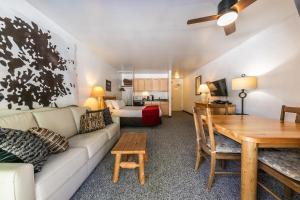 a living room with a couch and a table at Modern Studio w/Balcony #211 at Donner Lake Village in Truckee