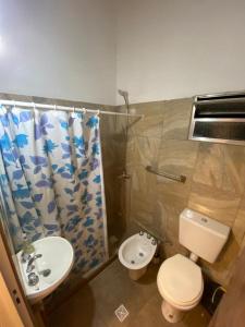 a bathroom with a toilet and a sink at La Casona de Susana in Colón