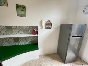a kitchen with a refrigerator and a shelf at La Casa di Brunina - Serenità a un passo dal Centro in Monza