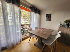 jadalnia z drewnianym stołem i krzesłami w obiekcie Appartement Paris Sud 53m2 - 2 chambres w mieście Malakoff