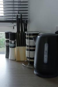 a kitchen counter with a black blender and some knives at Jacob's Place - rural location in Lanark