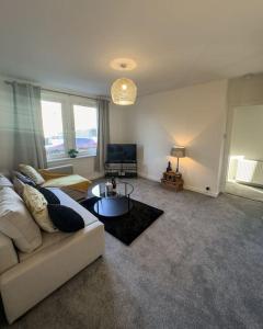 uma sala de estar com um sofá e uma mesa em Jacob's Place - rural location em Lanark