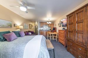 a bedroom with a large bed and a kitchen at Studio 2nd Floor Unit 217 Bldg B in Truckee