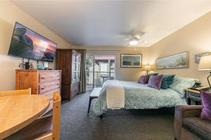 a bedroom with a bed and a couch and a table at Studio 2nd Floor Unit 217 Bldg B in Truckee