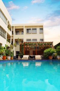 a swimming pool in front of a building at Cata Apartment Hotel And Spa in Ikeja