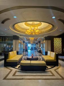 a lobby with couches and a chandelier in a building at Deluxe Room in Angeles