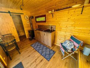 an overhead view of a cabin with a stove and a chair at Ranč Skalka in Rousínov