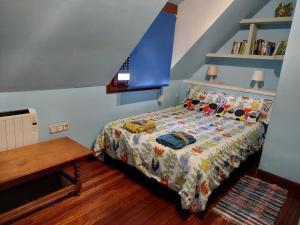 a bedroom with a bed and a wooden table at Alojamiento en TORRE SOLOKOETXE License LBI227 in Bilbao
