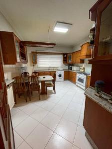 a kitchen with a table and chairs and a table and a kitchen with at Comfortable family apt - 1002 in Amman