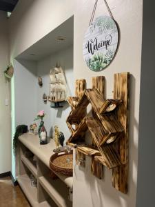 a room with a table with a wooden sign on the wall at The Garden Apartment, The Willow Apartment, & The Tropical Apartment at Casa of Essence in Old San Juan in San Juan