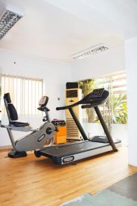 a gym with two treadmills on a treadmill at Cata Apartment Hotel And Spa in Ikeja