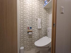 a small bathroom with a toilet and a wallpaper at Eslead Hotel Namba South III - Vacation STAY 37784v in Osaka +19 photos