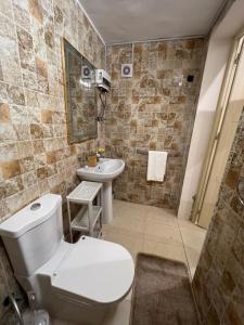 a bathroom with a toilet and a sink at Home sweet home in Obhor