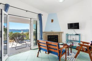 a living room with a fireplace and a balcony at Vista mozzafiato fronte mare in Olbia