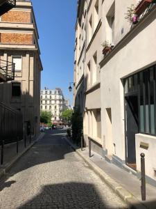 an empty street in a city with buildings at Loft 50m2 entre la Seine et le Panthéon in Paris