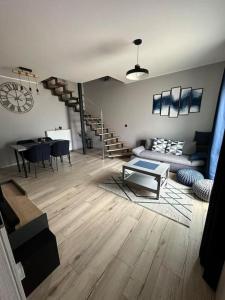 a living room with a couch and a table at Apartment Obi Osijek in Osijek