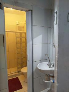 a bathroom with a sink and a toilet at Cantinho das Olandas in Olinda