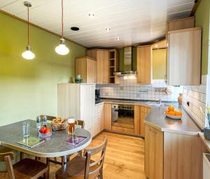 a kitchen with a table and some chairs in it at Teicher-Zoigl in Windischeschenbach