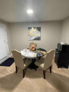 a dining room with a table and chairs and a printer at Lovely furnished apartment in Owings Mills