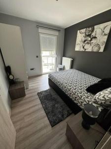 a bedroom with a bed and a rug in it at Apartment Obi Osijek in Osijek