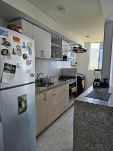 a kitchen with a stainless steel refrigerator and cabinets at Apartamento en Ibagué - Varsovia in Ibagué