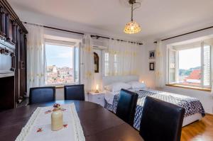 ein Schlafzimmer mit einem Bett und einem Tisch und Stühlen in der Unterkunft Apartment Ivona in Dubrovnik