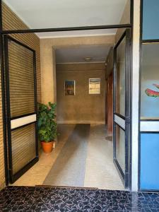 a hallway of a building with a plant in it at Diamond Apartment in Rome