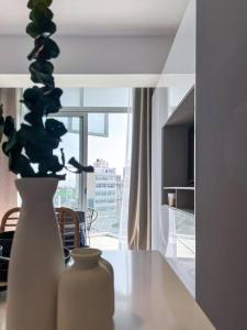 a white vase sitting on a table in a room at Chic 1BR Loft in the Heart of Roma Norte in Mexico City