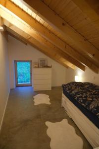 a attic room with a bed and a window at Maisonnette de campagne in Sion