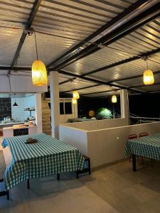 a room with two tables and a kitchen with lights at HOTEL NORCASIA RIOS Y AVENTURAS in Norcasia