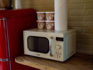 a microwave sitting on a counter next to a refrigerator at Stonegate Lodge King Bed, WIFI, 50in Roku TV, Salt Water Pool Room #103 in Eureka Springs