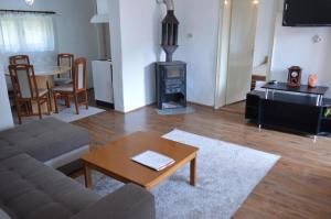 a living room with a couch and a wood stove at Kuca Rancic in Pirot