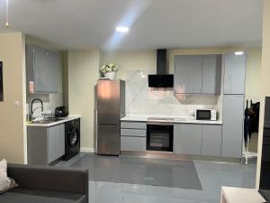a kitchen with a stainless steel refrigerator and a dishwasher at ApartaSoles in Valladolid