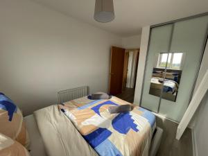 a bedroom with a bed and a large window at Balcony Apartment - Views Of Etihad Stadium - Near CoOp Live Arena in Manchester