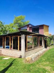 a house that is being built with glass at Finca Buenos aires in Oicatá