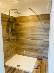 a shower with a glass enclosure in a bathroom at Chez Laura-Marie & Alex in Porto-Vecchio