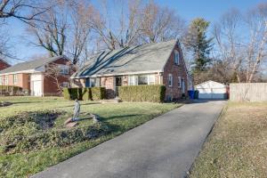 a red brick house with a gray roof and a driveway at Lovely Lexington Home 4 Mi to Downtown! in Lexington