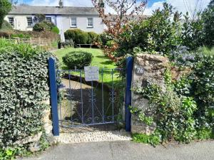 a gate to a house with a sign on it at The Captain's House Charlestown St Austell in Charlestown