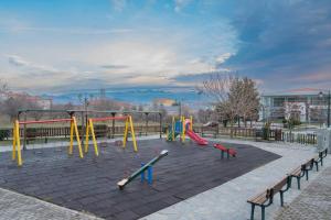 a playground with colorful equipment in a park at Frida's Home for 2 in Kozani in Kozani