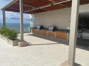 an outdoor bar with a view of the ocean at Aparta estudio tipo suit , nuevo , dotado en Playa Salguero in Santa Marta