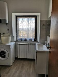 a bathroom with a washing machine and a sink at ROSEMARIN in Koper